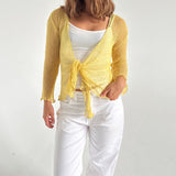 Modelfoto af pige som bærer en Arabella bluse i gul, samt et par hvide jeans. Alt fra By Sofie Sønderby