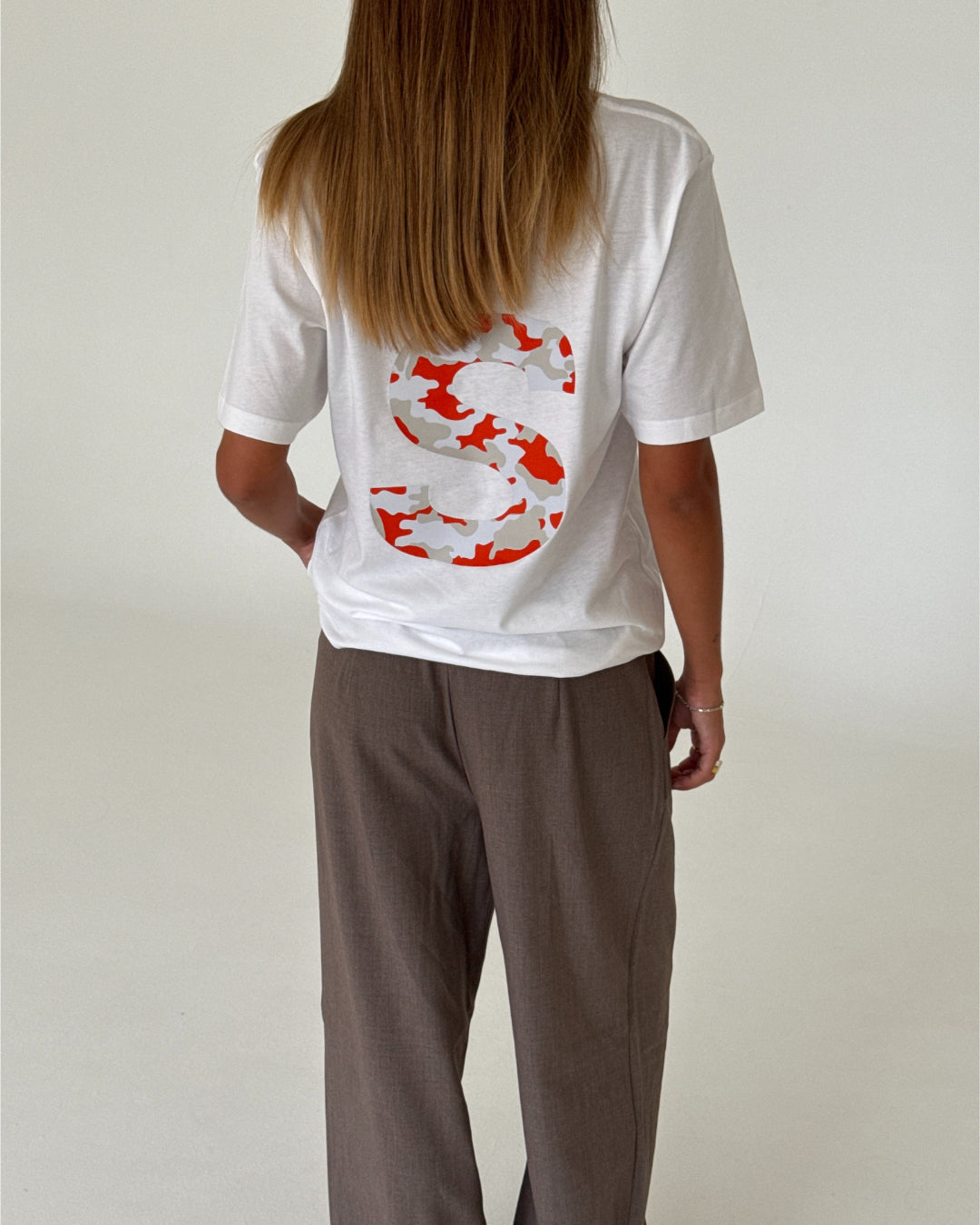 Modelbillede af BIG S t-shirt, hvid/rød camouflage og KARI bukser, sand. Begge fra BySofieSønderby