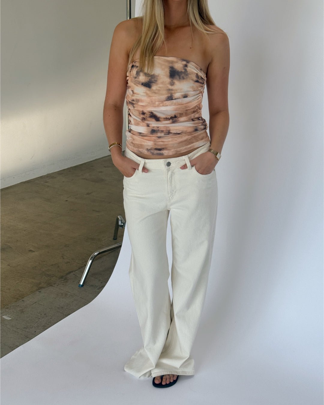 Modelbillede af BINE stropløs top, beige og NANNA wide leg jeans, hvid. Fra BySofieSønderby