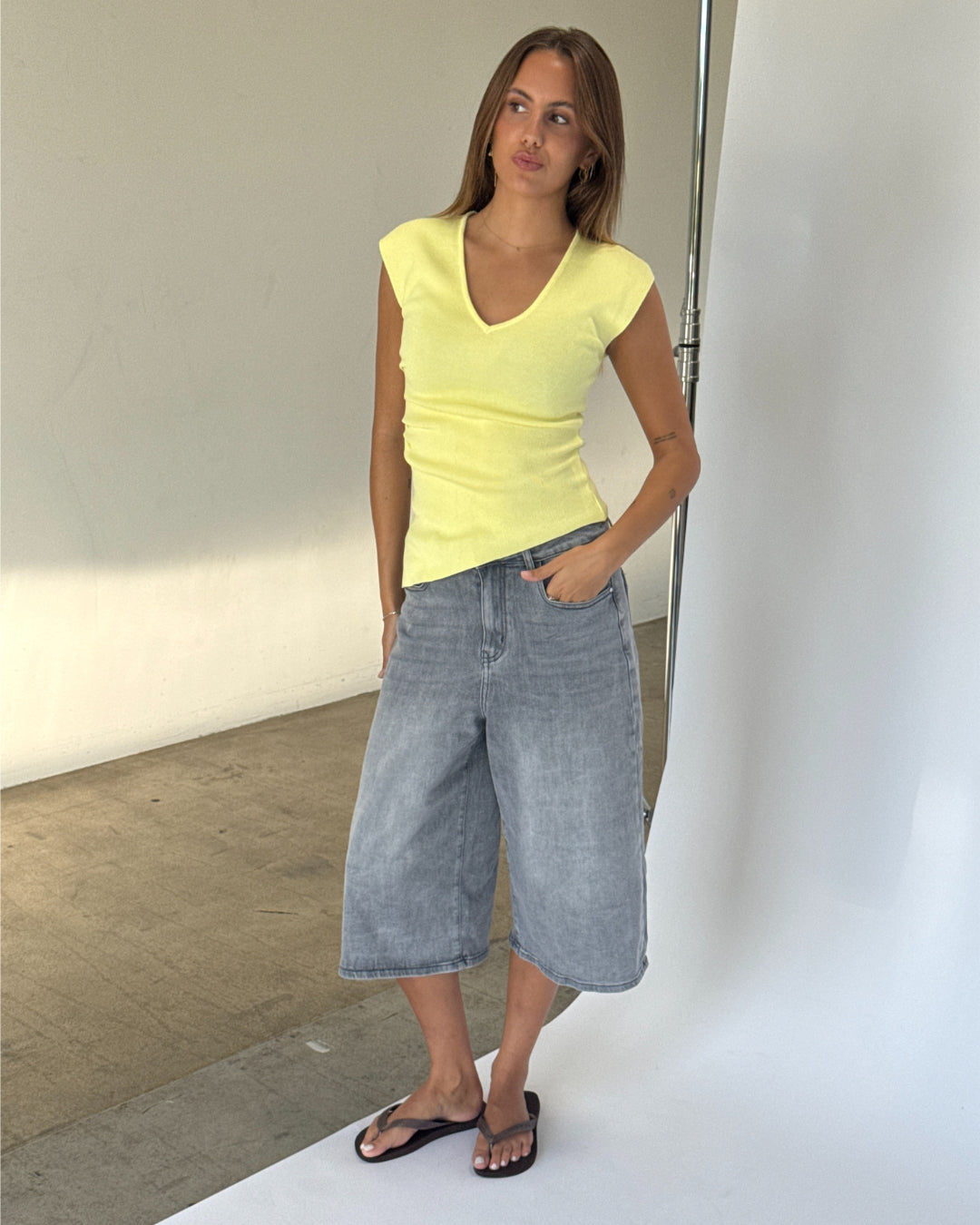 Modelbillede af SERENA top, lysegul og MADDIE denim jorts, grå. Fra BySofieSønderby