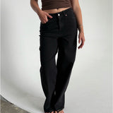Modelfoto af pige som bærer et par sorte Tokyo jeans, samt iført en brun Thora top og sorte Carmen sandaler. Alt fra By Sofie Sønderby